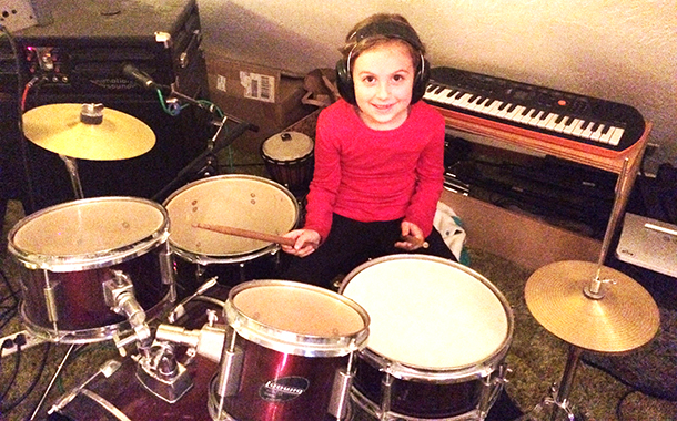 Cali, 6, playing drums